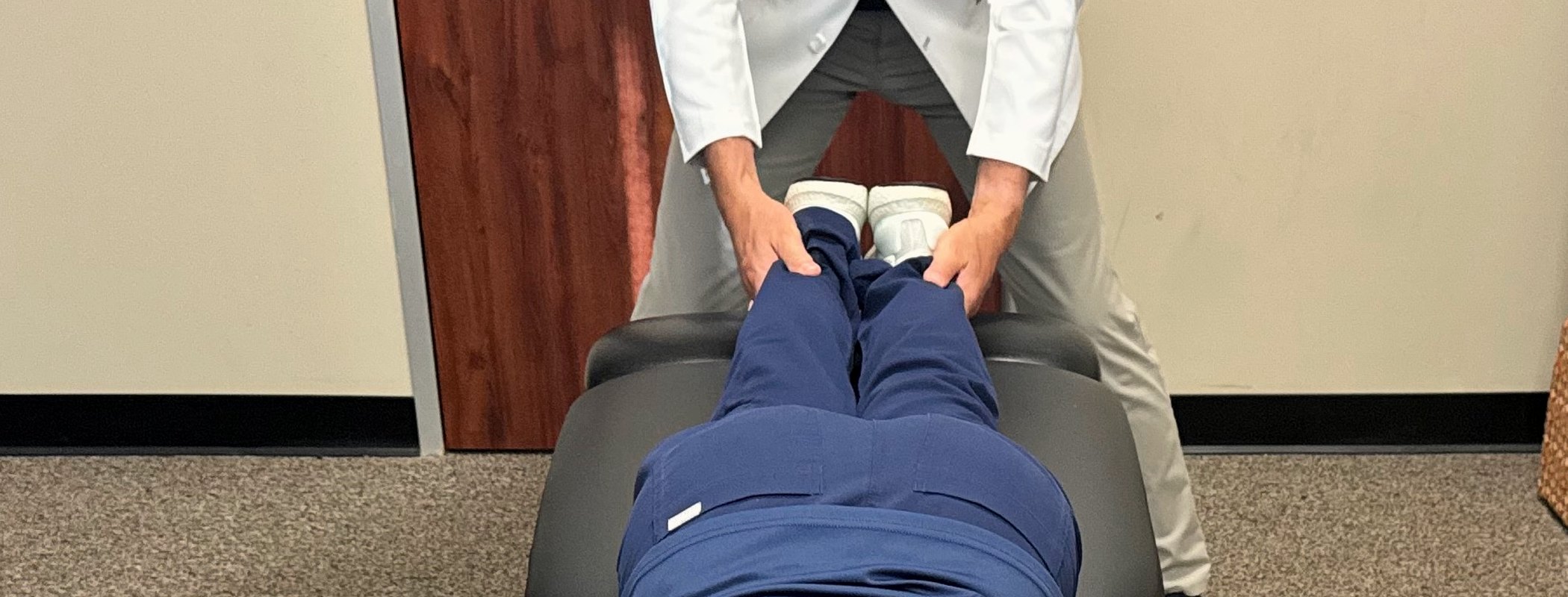 Indicator 1, leg lengths: with the patient face-down, the chiropractor brings both heels together to compare them